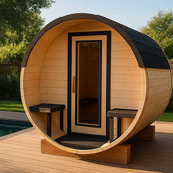 Barrel-shaped outdoor sauna on a wooden poolside deck surrounded by lush greenery under a clear blue sky.