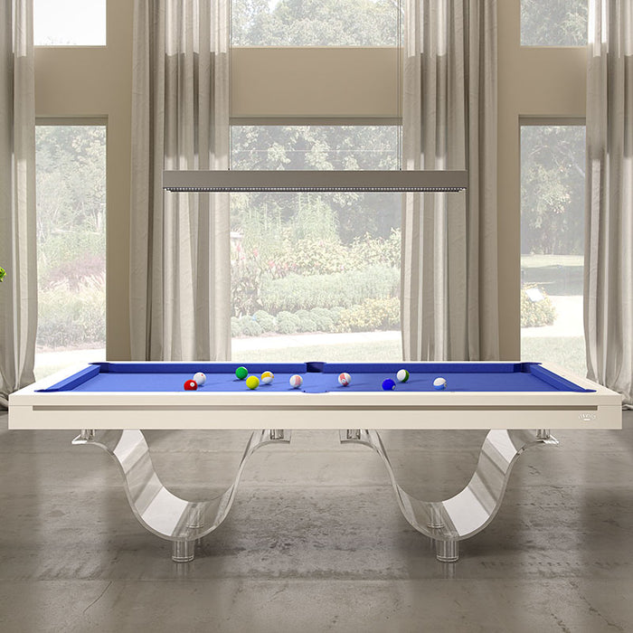 Front-facing view of the Etrusco Onda Marina Pool Table featuring blue felt and acrylic curved legs, set against large windows with elegant curtains.