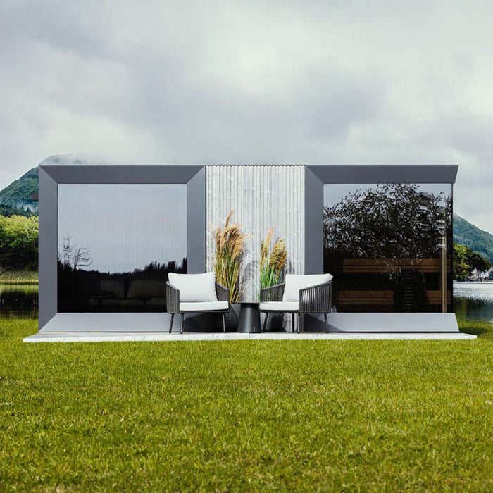 Front-facing view of Geneva St. Moritz outdoor sauna with shower room, framed by trees in bloom and minimalist decor.