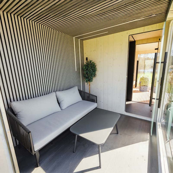 Indoor-to-sauna view from the Geneva St. Moritz outdoor unit, showing seamless transition to the sauna cabin with panoramic glazing.