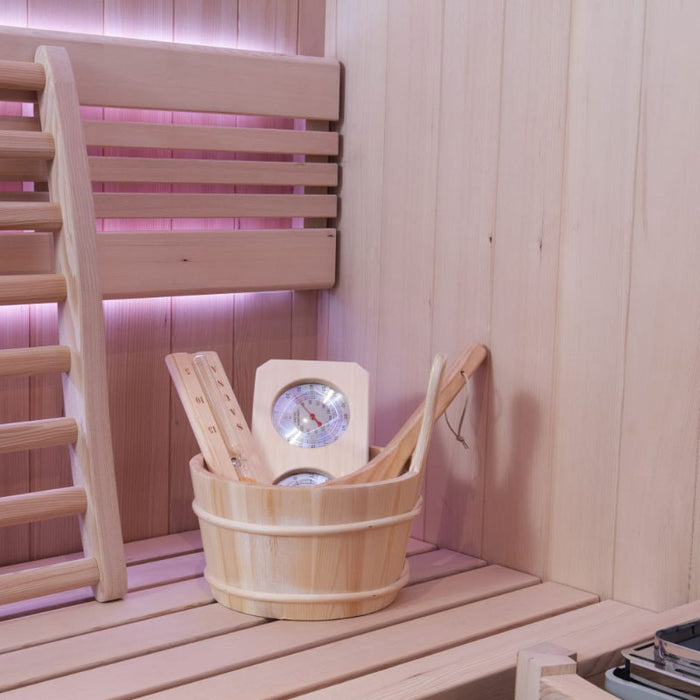 A luxury infrared sauna featuring ergonomic wooden seating, soft pink LED glow, and premium sauna tools for a relaxing spa experience.