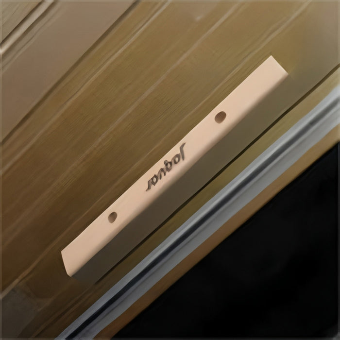 A premium wooden handle on a transparent glass door, engraved with the Jaquar logo for a refined touch.