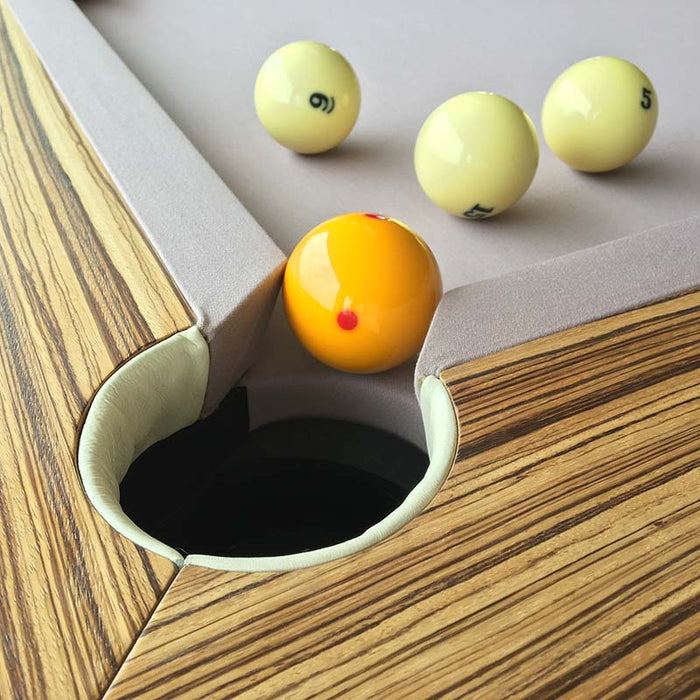 Corner detail of an MBM Biliardi Ziggurat pool table, highlighting the wood frame and smooth lilac playing surface.