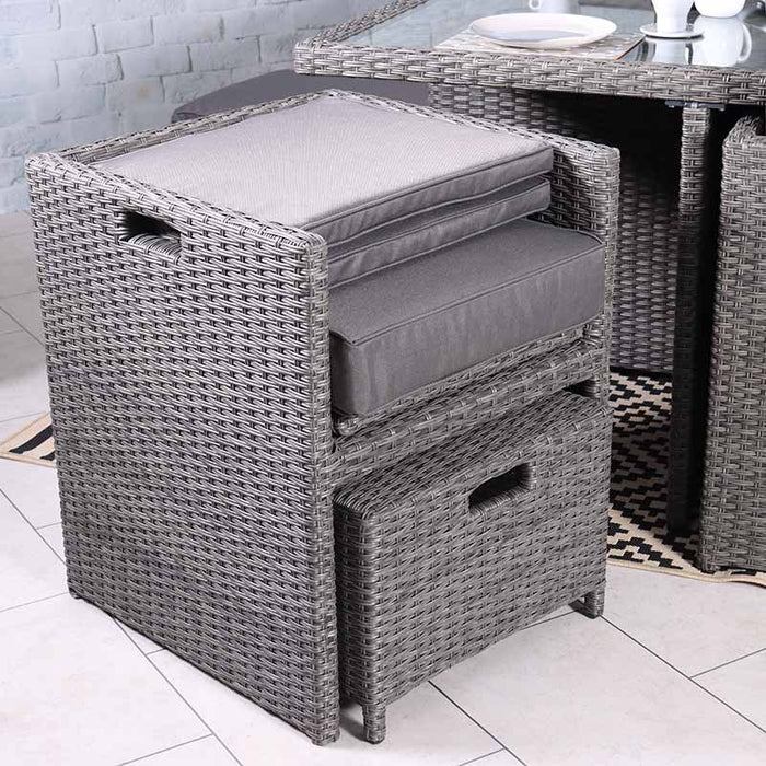 The Paris 10 Seater Cube Set showing stacked grey cushions neatly arranged on a rattan chair, demonstrating the set’s convenient storage options.