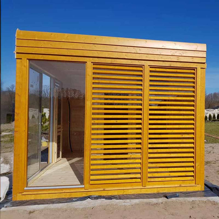 Side view of the Sauna Cube 3 x 4m in a garden.