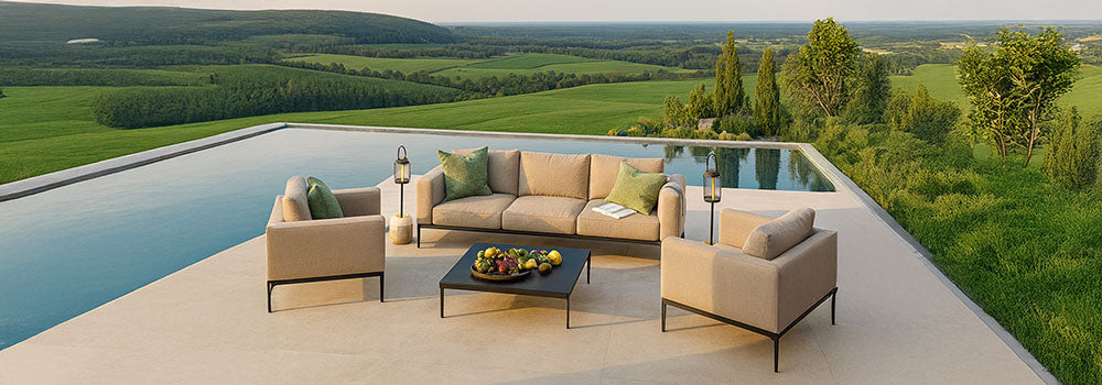 modern beige garden sofa set with black metal frame on a terrace overlooking an infinity pool and scenic countryside hills at sunset.
