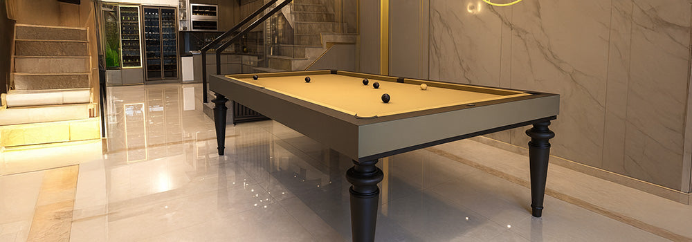 sleek pool table with beige felt in luxurious modern interior featuring marble floors and staircase.
