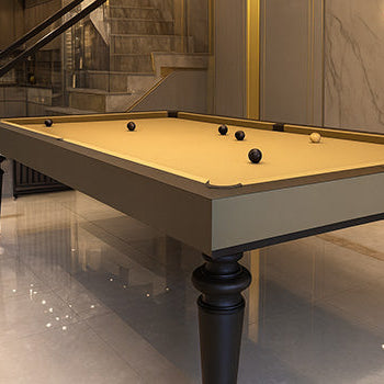 sleek pool table with beige felt in luxurious modern interior featuring marble floors and staircase.