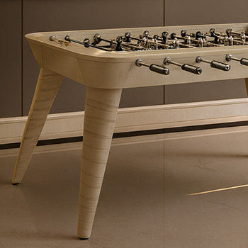 Elegant cream-colored foosball table in a luxurious modern room with marble floors and gold-framed digital art.