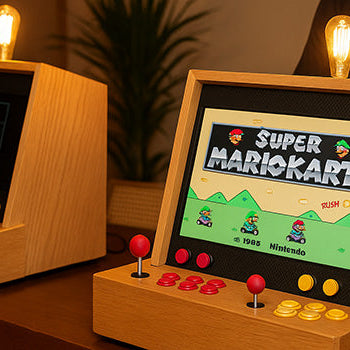 Enhanced wooden arcade machines on a polished table, one showing Super Mario Kart under warm ambient lighting.