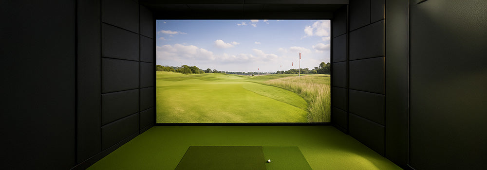 Sleek indoor golf simulator with lush fairway projection and green turf flooring.