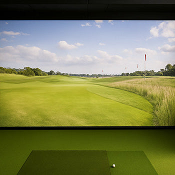 Sleek indoor golf simulator with lush fairway projection and green turf flooring.