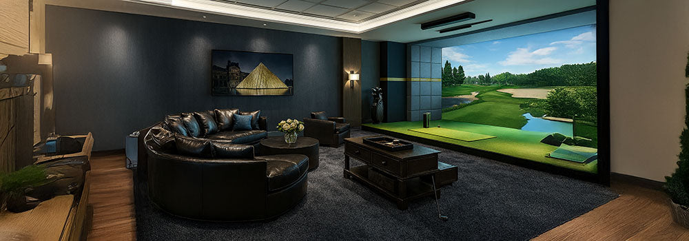Luxury golf simulator lounge with black leather seating and dark blue walls.