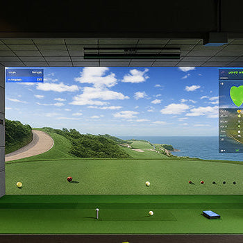 Premium golf simulator suite with ocean course view and marble coffee table.