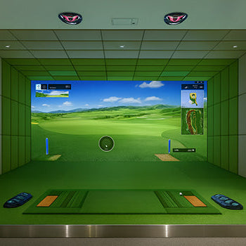 Indoor golf simulator setup with turf mat, fairway projection, and touchscreen kiosk in a softly lit room.