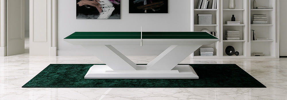 green luxury ping pong table with sculptural white base in a marble-floored study with abstract art and built-in shelves.