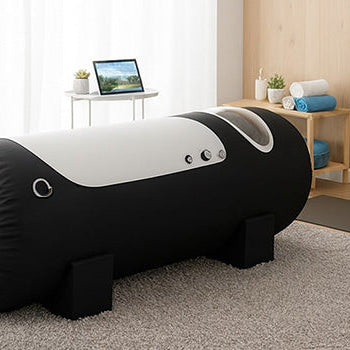 Sleek black and white hyperbaric oxygen chamber in a serene wellness room with soft lighting and modern decor.
