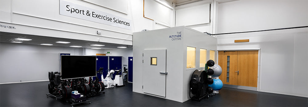 Hypoxic Therapy training room with cardio equipment behind glass and an AlterG anti-gravity treadmill in a modern rehabilitation facility.