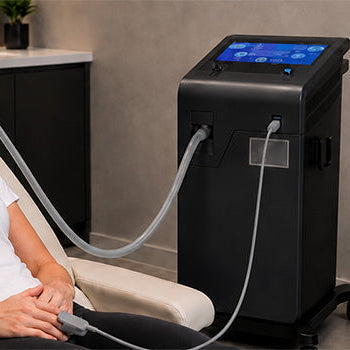 Woman receiving supervised Hypoxic Therapy through a breathing mask with specialist equipment monitoring her simulated altitude training session.