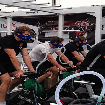 Athletes using Hypoxico breathing masks during treadmill and cycling exercises for simulated altitude, cardio and endurance training.