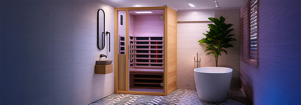 Contemporary indoor infrared sauna with purple lighting in a luxury bathroom with marble walls, herringbone floor tiles, and freestanding bathtub.