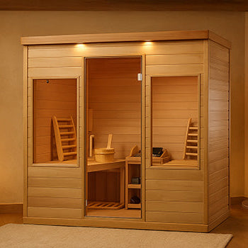 Light wood indoor sauna in a cozy, candle-lit wellness room with neutral decor.