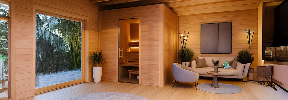 Modern indoor sauna in a cozy wooden wellness room with bamboo garden view.