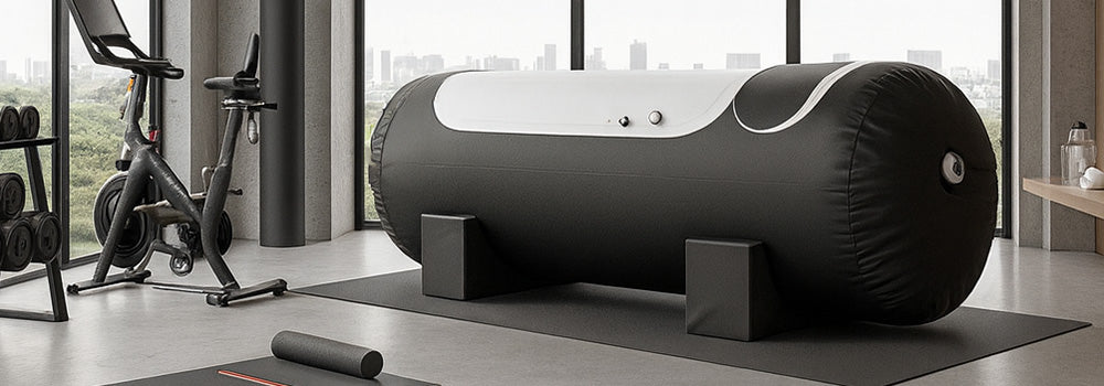 Inflatable black hyperbaric oxygen chamber in an upscale urban gym with panoramic windows, modern fitness gear, and concrete floors.