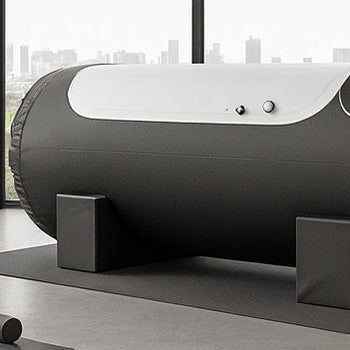 Inflatable black hyperbaric oxygen chamber in an upscale urban gym with panoramic windows, modern fitness gear, and concrete floors.