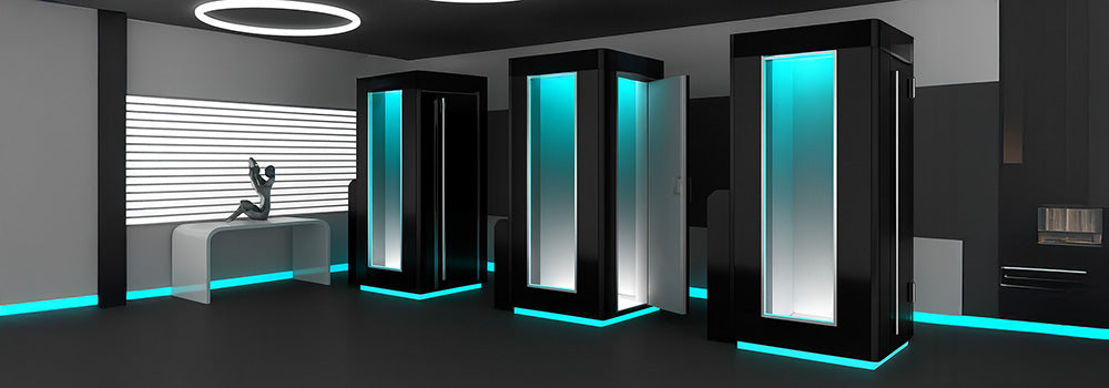 Futuristic cryotherapy studio with three LuxCryo chambers glowing with turquoise LED lighting.