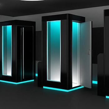 Futuristic cryotherapy studio with three LuxCryo chambers glowing with turquoise LED lighting.