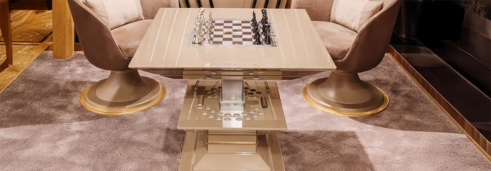Luxury chess set on a beige game table in a designer billiards room with cue rack and velvet chairs.