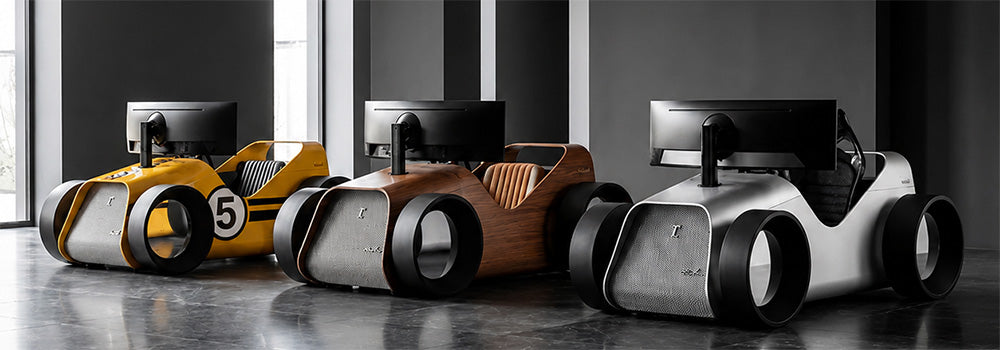 Three luxury car-inspired racing simulator cockpits with integrated monitors in yellow, wood-effect and silver finishes.