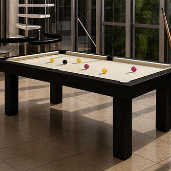 modern atrium with glass walls and white spiral staircase featuring black pool table with cream felt.