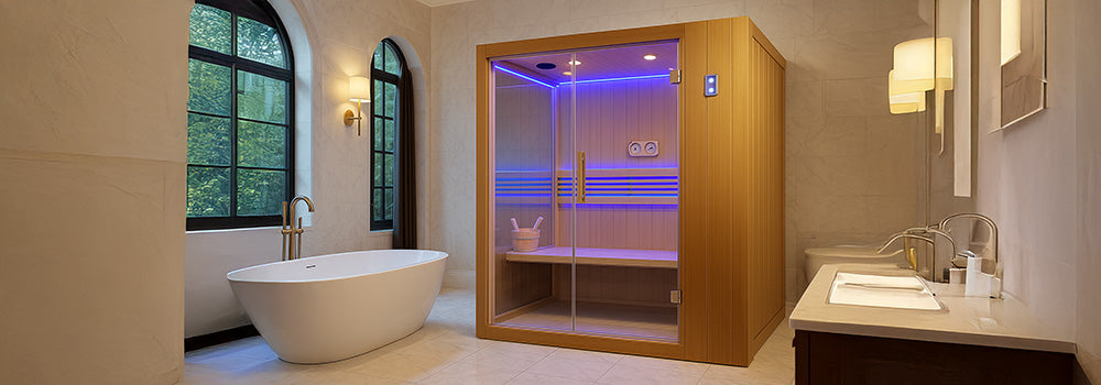 Modern indoor sauna with blue LED lighting in a luxury marble bathroom with freestanding tub.