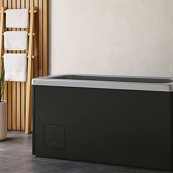 Ice bath in a serene spa room with wood paneling and natural light.