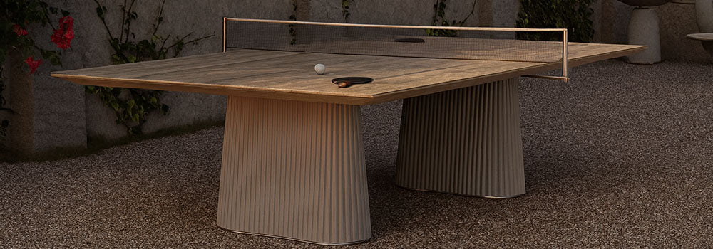 outdoor luxury ping pong table in Mediterranean courtyard with climbing ivy and soft sunset lighting.