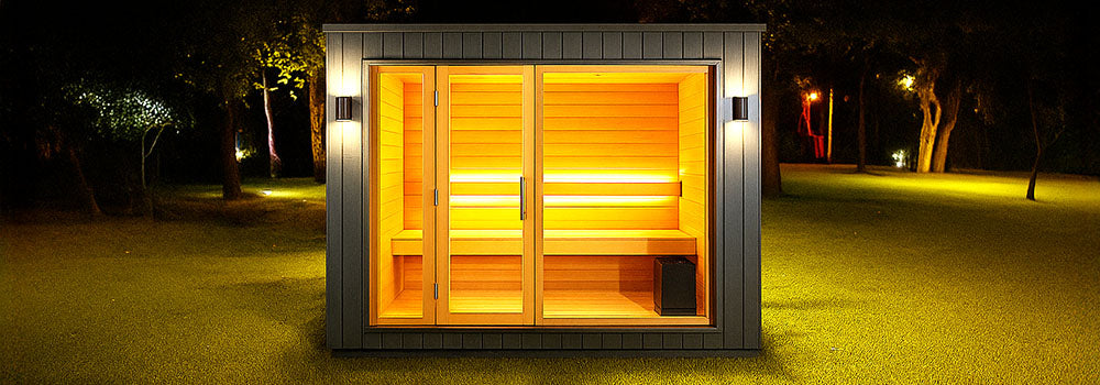 Modern outdoor sauna with illuminated wooden interior set in a dark garden at night with soft ambient lighting.