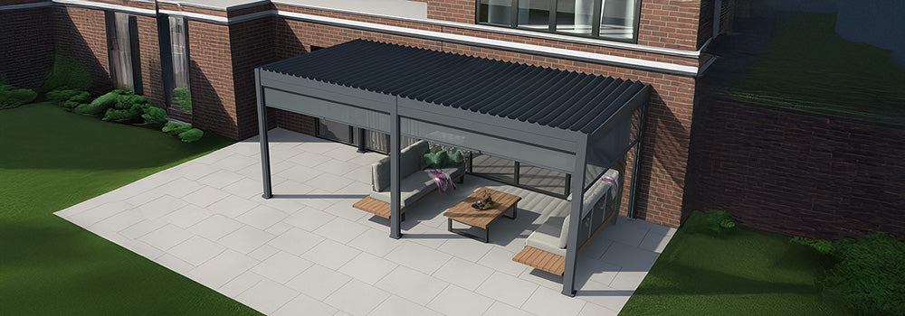 Stylish grey pergola with lounge seating on a large tiled patio beside a modern red brick house.