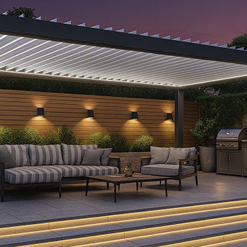 Evening pergola with striped cushioned seating and built-in lighting on a raised patio with illuminated steps.