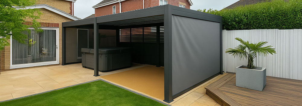 Grey pergola with privacy screens sheltering hot tub on patio beside suburban home.