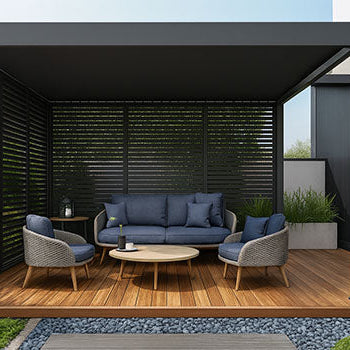 Modern pergola with slatted privacy panels and blue cushioned lounge set on wooden deck.