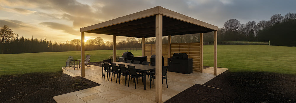 Wood pergola covering outdoor dining and barbecue area on a patio overlooking countryside fields.