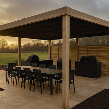 Wood pergola covering outdoor dining and barbecue area on a patio overlooking countryside fields.