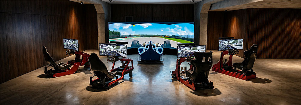 Premium sim racing centre with multiple racing simulator cockpits, steering wheels, gaming monitors and a large immersive racing display.