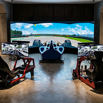 Premium sim racing centre with multiple racing simulator cockpits, steering wheels, gaming monitors and a large immersive racing display.