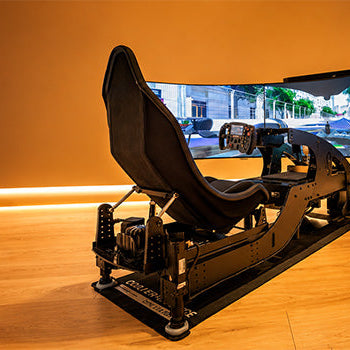 Professional motion sim racing cockpit with bucket seat, racing wheel and immersive triple curved-screen display in a premium gaming room.