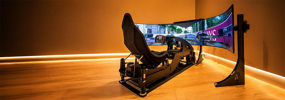 Professional motion sim racing cockpit with bucket seat, racing wheel and immersive triple curved-screen display in a premium gaming room.