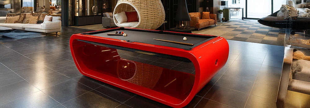 glossy red designer pool table in a contemporary loft-style showroom with modern furniture.