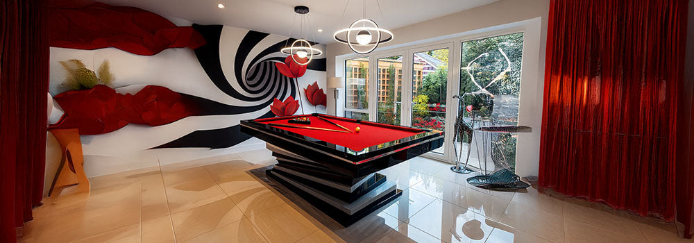 modern red felt snooker table in luxury indoor game room with spiral wall art and garden view.